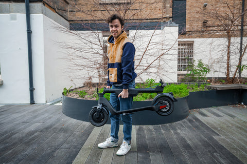 Our reviewer riding Riley RS1 electric scooter